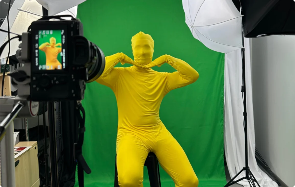 The Yellow Man posing in front of a green screen at a bibidi photo shoot