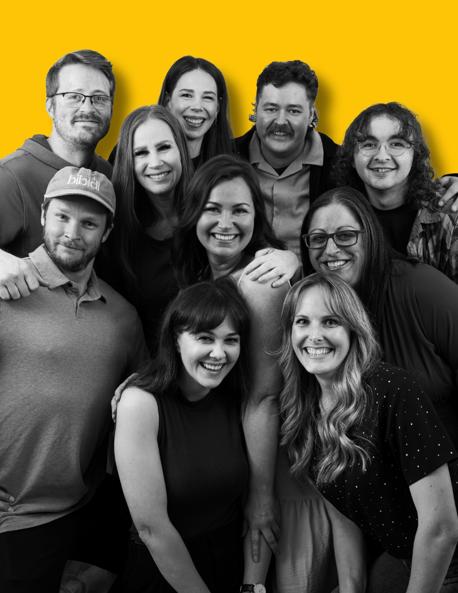 The bibidi team together against a yellow background